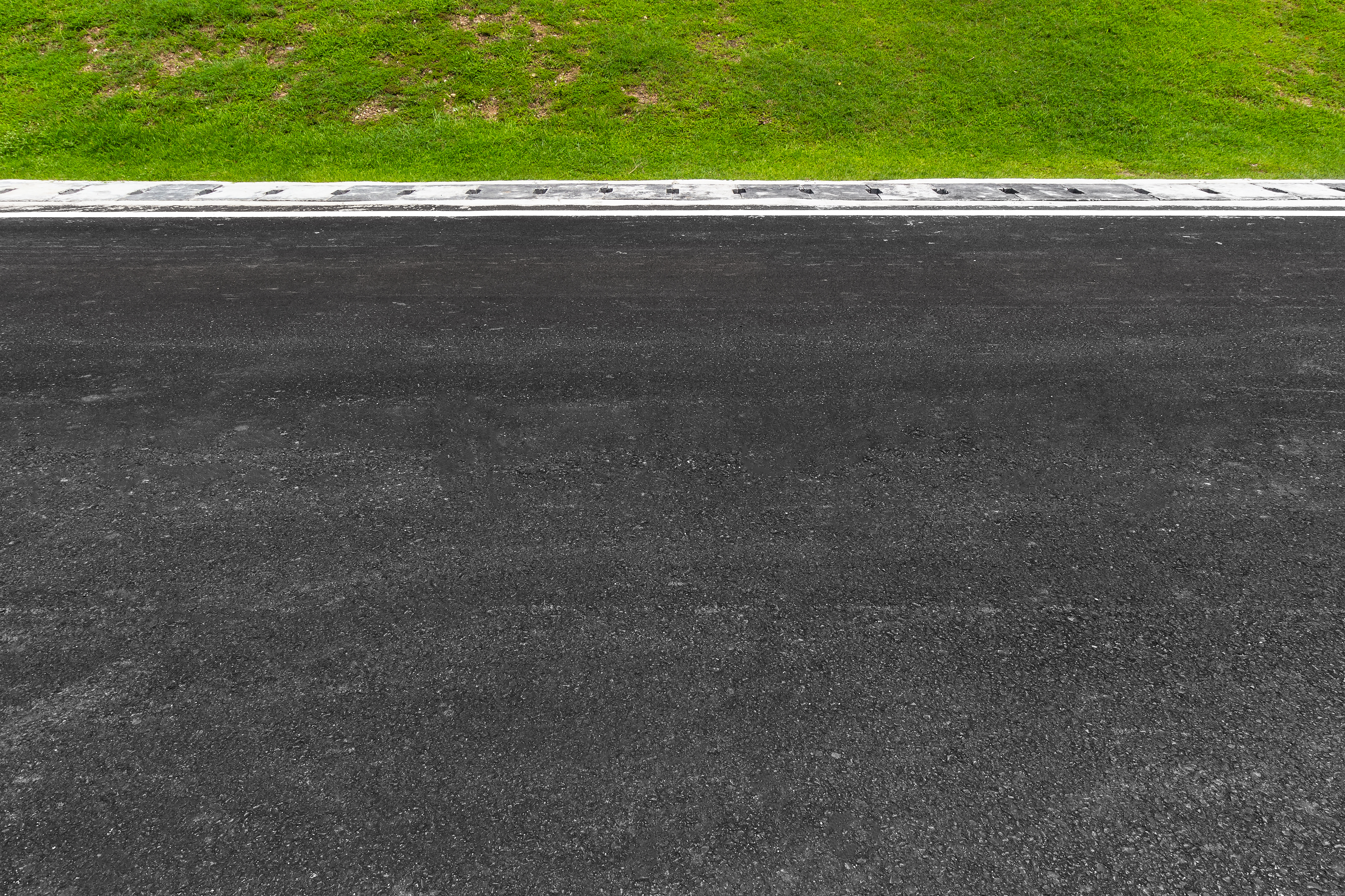 vecteezy_asphalt-road-with-stripes-and-green-grass-texture_4876639
